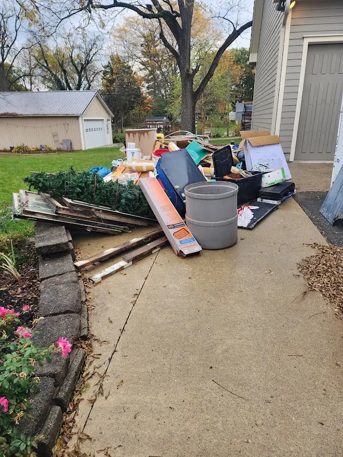 Dumpster being loaded with debris for 30 Yard Dumpster Rental in Maumee